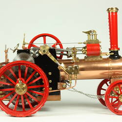 Model steam traction engine in metal, painted black and red.