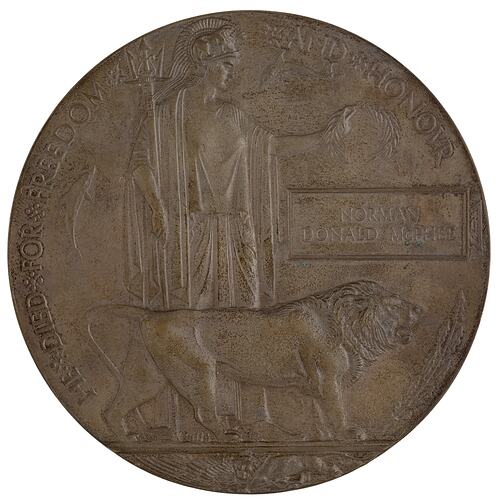 Bronze coloured medal with lion and woman holding trident and wreath.