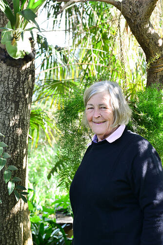 Woman beside a tree.