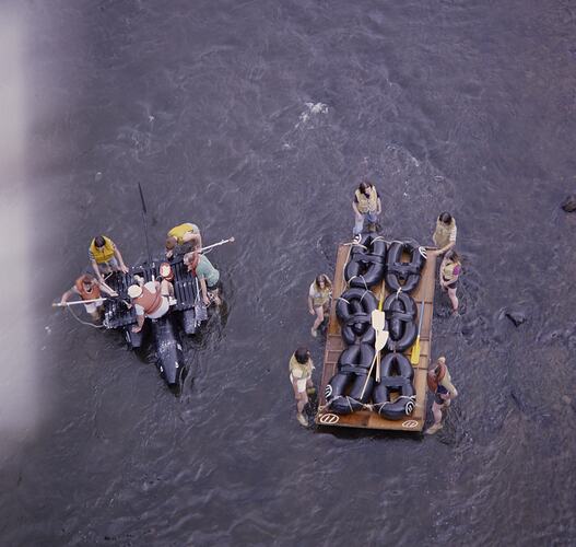 Aerial view of people on river rafts.