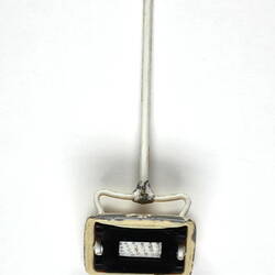 Plastic toy carpet sweeper, underside.