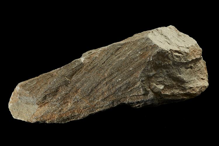 Pale rock with surface striations.