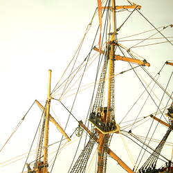 Detail of main and rear masts on model ship, showing crowsnest and rigging.
