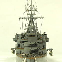 Naval ship with two masts, front view.