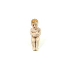 Tiny toy baby, front view.