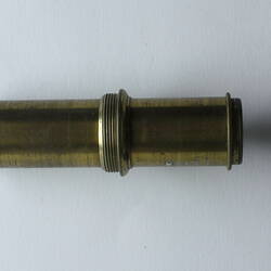 Short narrow brass scientific instrument.
