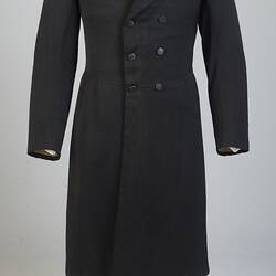 Gentleman's black cotton frock coat, six-button, double-breasted with peaked lapels.