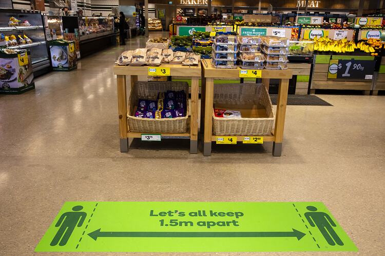 Green floor marker in supermarket.