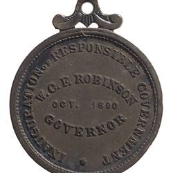 Medal with raised text in centre and raised text around edge. Loop at top.