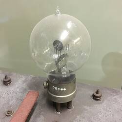 Glass round globe on metal base.