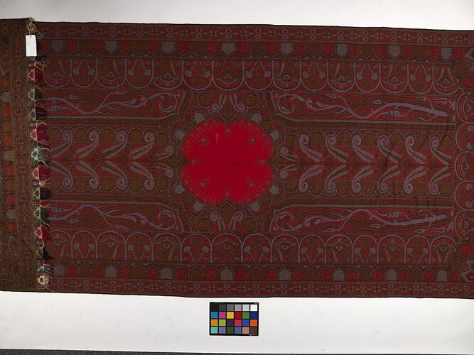 Finely woven red twill tapestry shawl with paisley design in red, orange, black, white and blue.