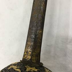 Detail of sword hilt. Engraved blade.