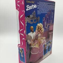 Back of barbie doll box. Image of Barbie and Ken with blue background.