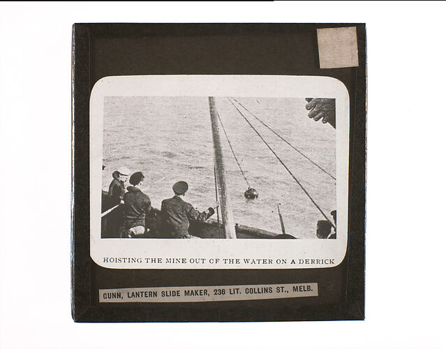 Lantern Slide - Hoisting the Mine out of the Water on a Derrick