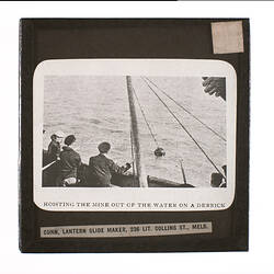 Lantern Slide - Hoisting the Mine out of the Water on a Derrick