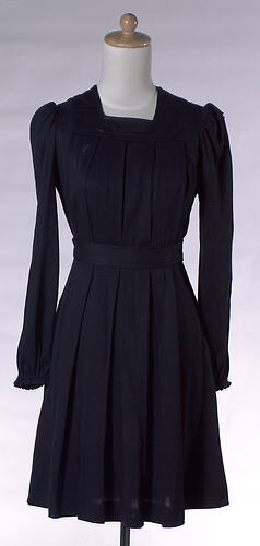 Tunic style black mini dress, pleated at front.