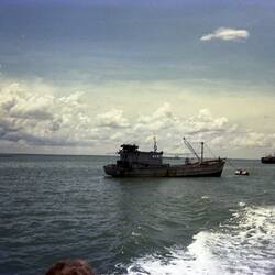 Boat, probably a fishing trawler, at sea.