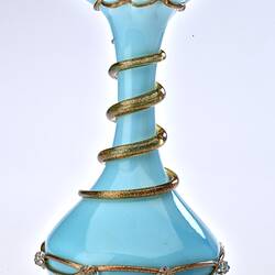 Pale blue opaque glass vase with gilded ribbon spiralling from base up to top. Flared neck with frill at top.