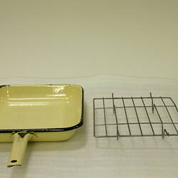 Rectangular yellow enamel grill pan with handle. Removable wire rack sits beside pan.