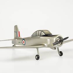 Model aeroplane, silver with black propeller and wheels. Red, white, blue roundels on body and flag on tail.