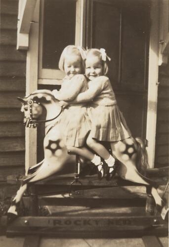 Digital Photograph - Twin Girls Riding on Hobby Horse 'Rocky Ned', St Kilda, 1947