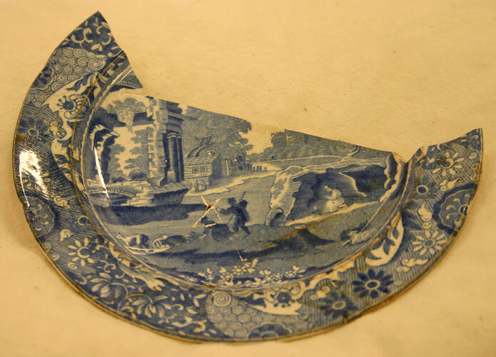 Broken blue and white ceramic plate.