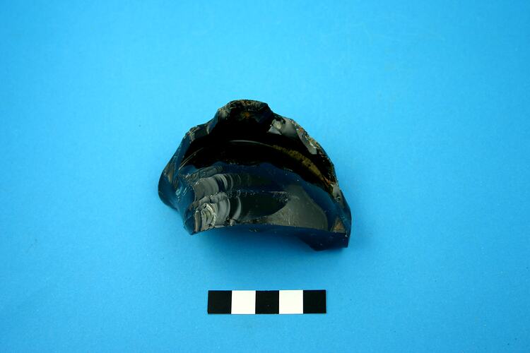 Fragment of dark green glass bottle base.
