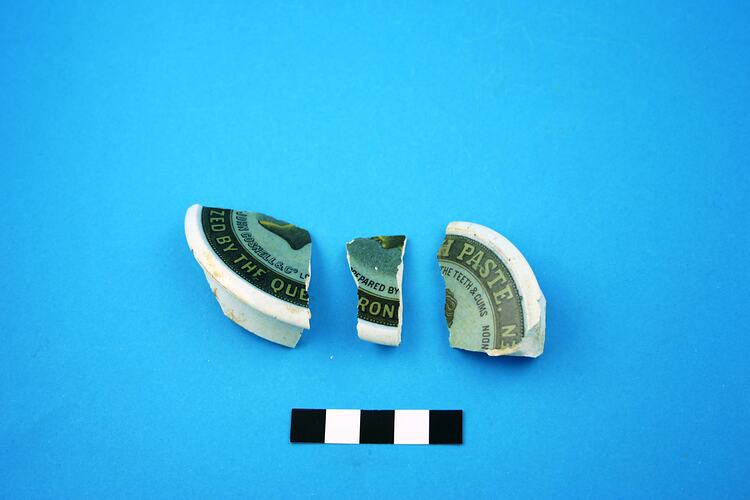 Three fragments of earthenware lid of pot.