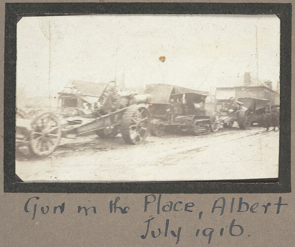 Convoy of military vehicles on a street.