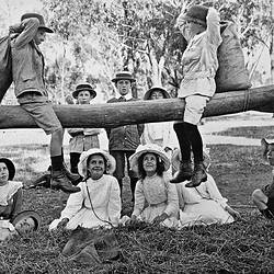 Negative - Two Boys on Log Sack Fighting Watched by a Group of Children, Merrigum, Victoria, 1910