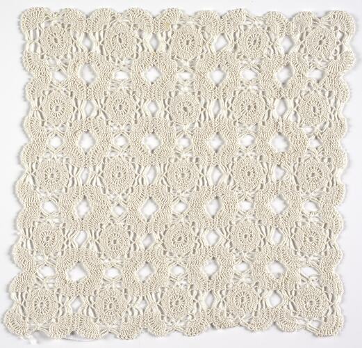 Square of intricate cream lace.