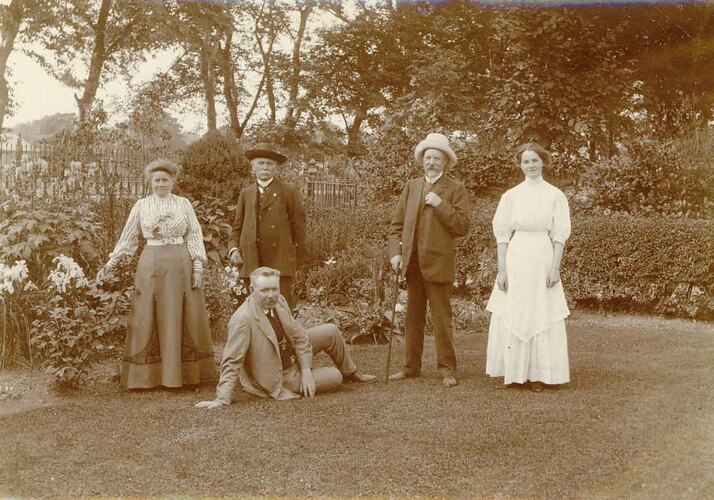 H.V. McKay posing with two men and two women in a garden.
