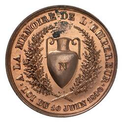 Round medal, central urn framed by wreath. Text around.