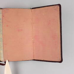 Open diary, inside cover and front page pale pink colour possibly from red cover.