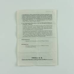 Paper with typewritten text in German.