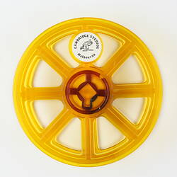 Circular plastic film reel with eight spokes.