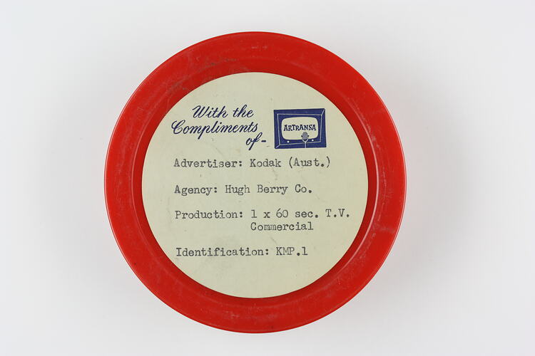 Small, circular, labelled plastic film container.