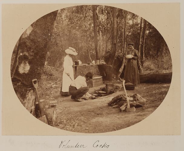 People cooking on a campfire in the bush.