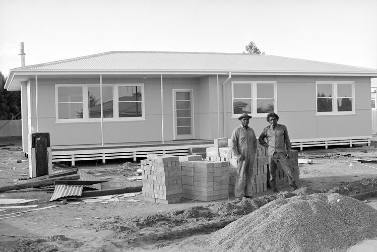 Unidentified men in front of housing, Port Augusta, South Australia, August 1968