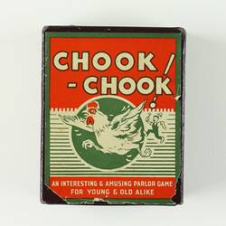 Game box with man chasing large rooster.