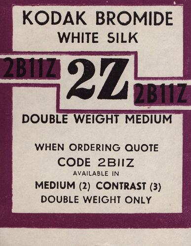Maroon and white paper label with printed text.