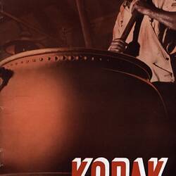 Tinted photograph of man stirring an industrial vat.