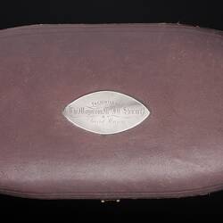 Custom oval-shaped, brown leather case for presentation trowel.