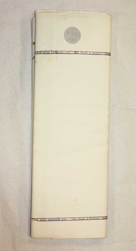 Bundle of sheets with label, tied with tape.