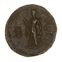 Round coin, aged, facing left, right hand holding flower, left hand lifting her clothing.